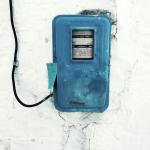 blue corded electronic appliance mounted on white painted wall