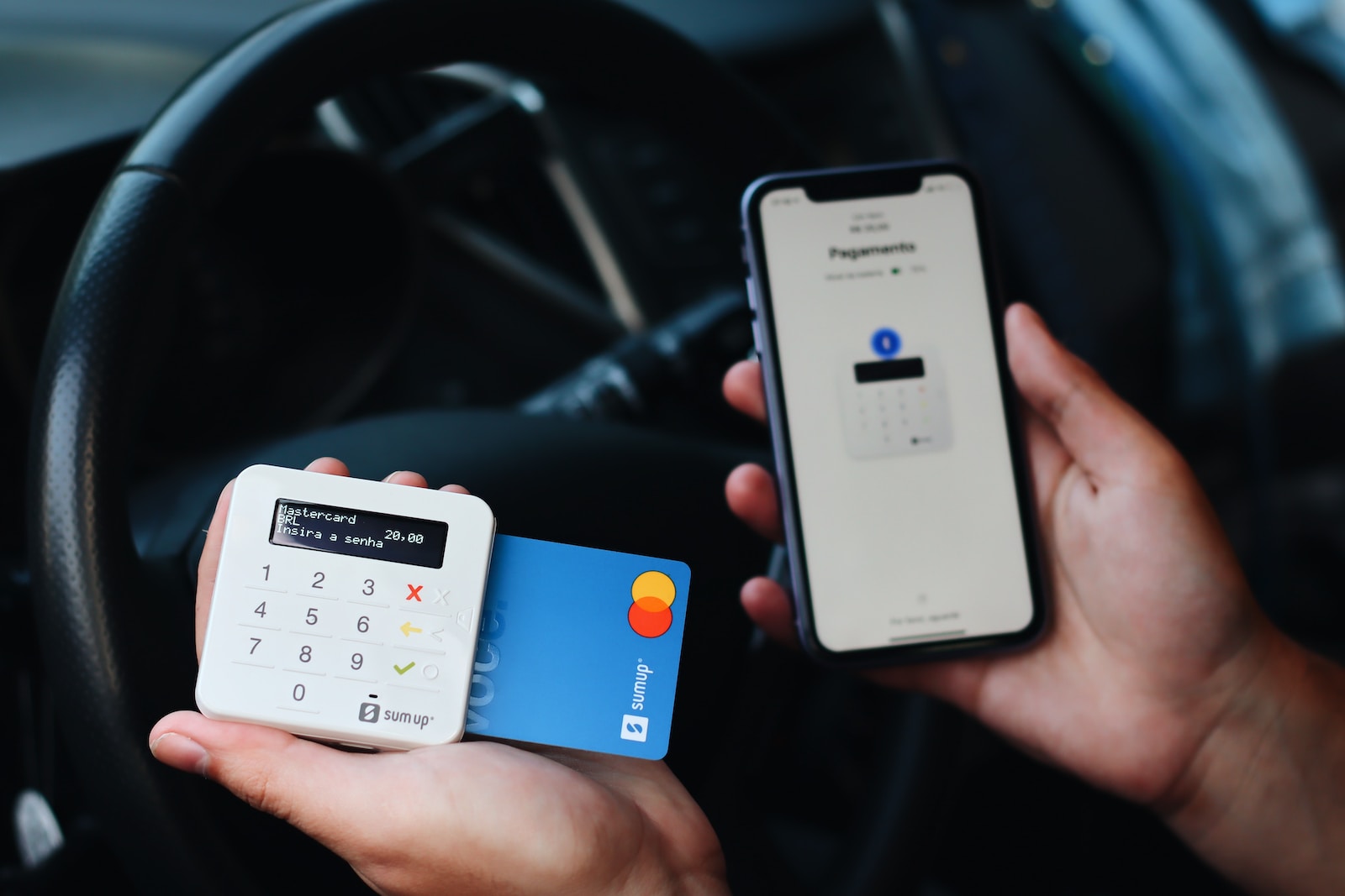 a person holding a credit card and a mobile phone