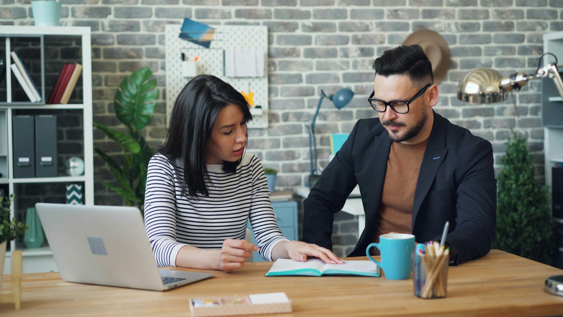 office workers sitting at a table and discussing strategy